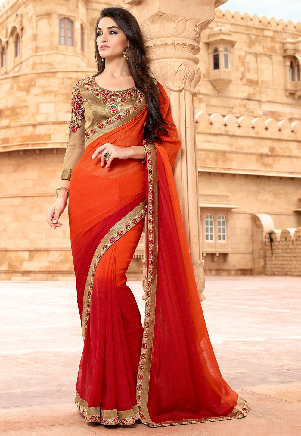 A shaded orange and red faux chiffon jacquard saree. (Image: Utsavfashion.com)